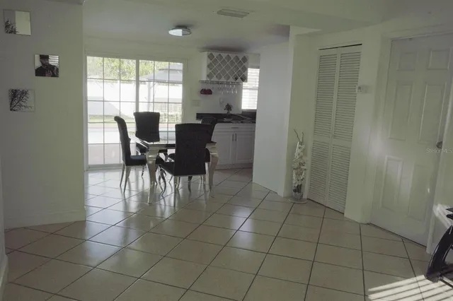 a view of a dining room with furniture and window