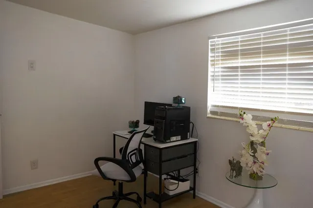 a bed sitting in a bedroom next to a window