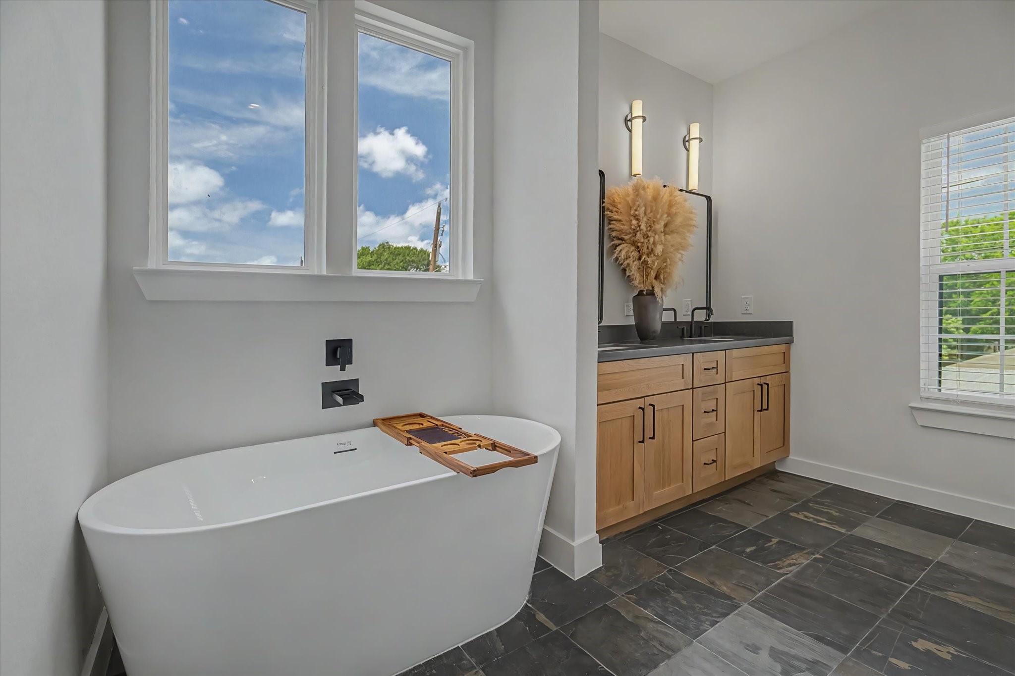 3806 Dreyfus Street Houston, TX 77021 - Photo 25 of 48 Primary bathroom featuring a soaking tub, slate flooring, and dual sinks.