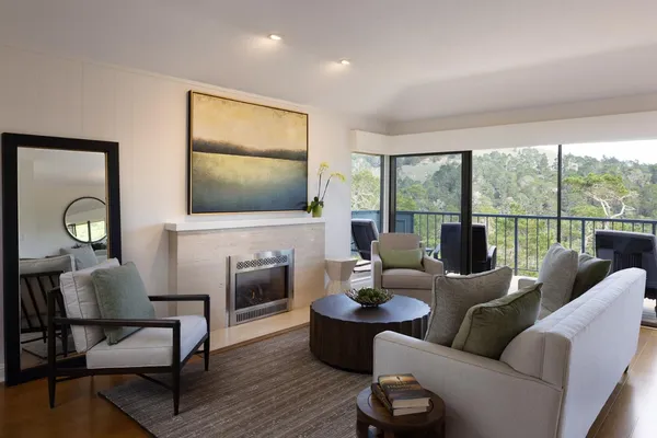 a living room with furniture tv and a large window