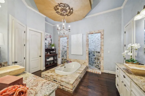 a bathroom with a tub sink and mirror