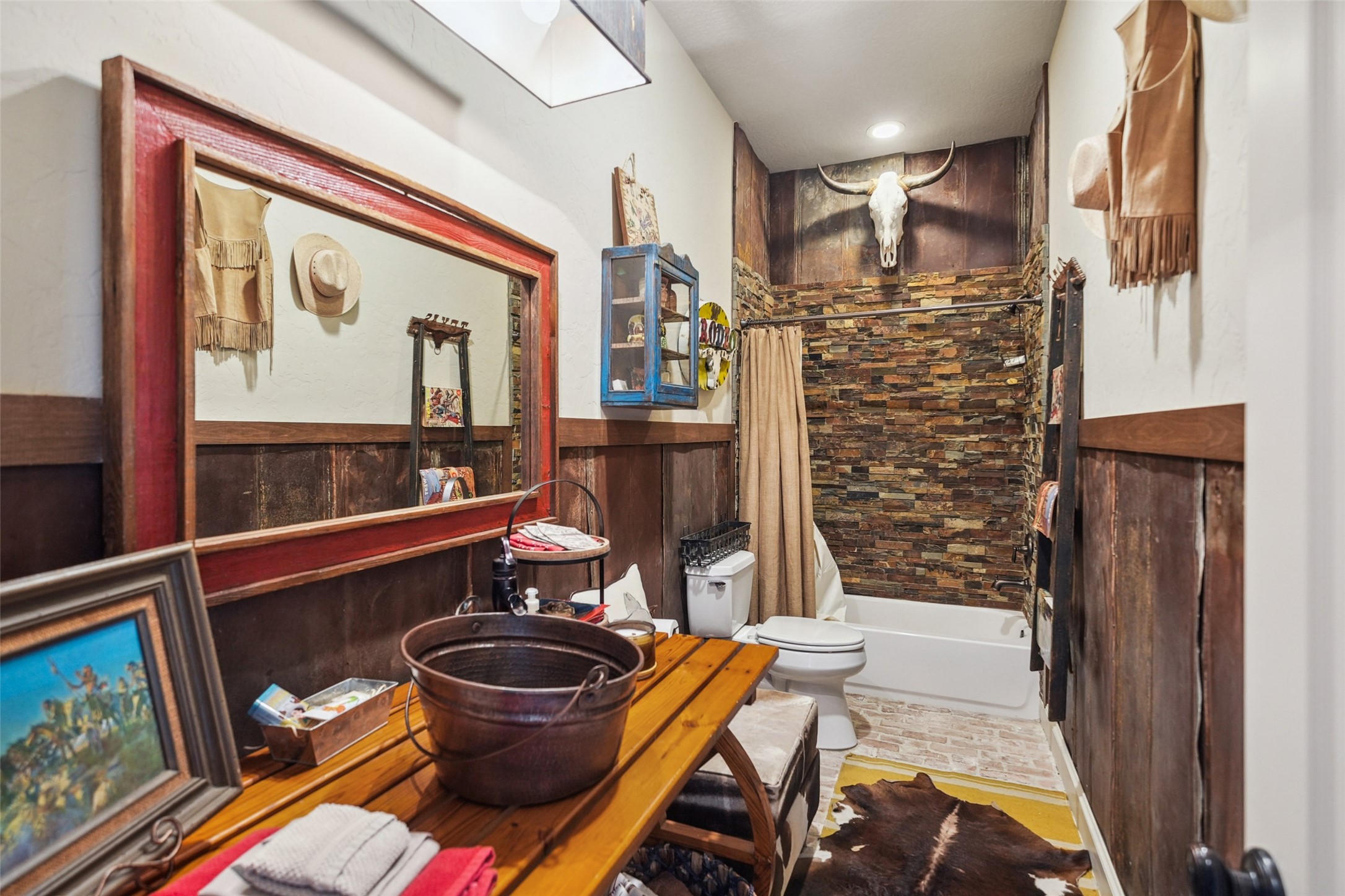 460 Bishop Road Huntsville, TX 77320 - Photo 21 of 50 Connected full bathroom includes brick flooring, a stone-accented shower, a unique copper bucket sink, and vintage-inspired pressed tin details.