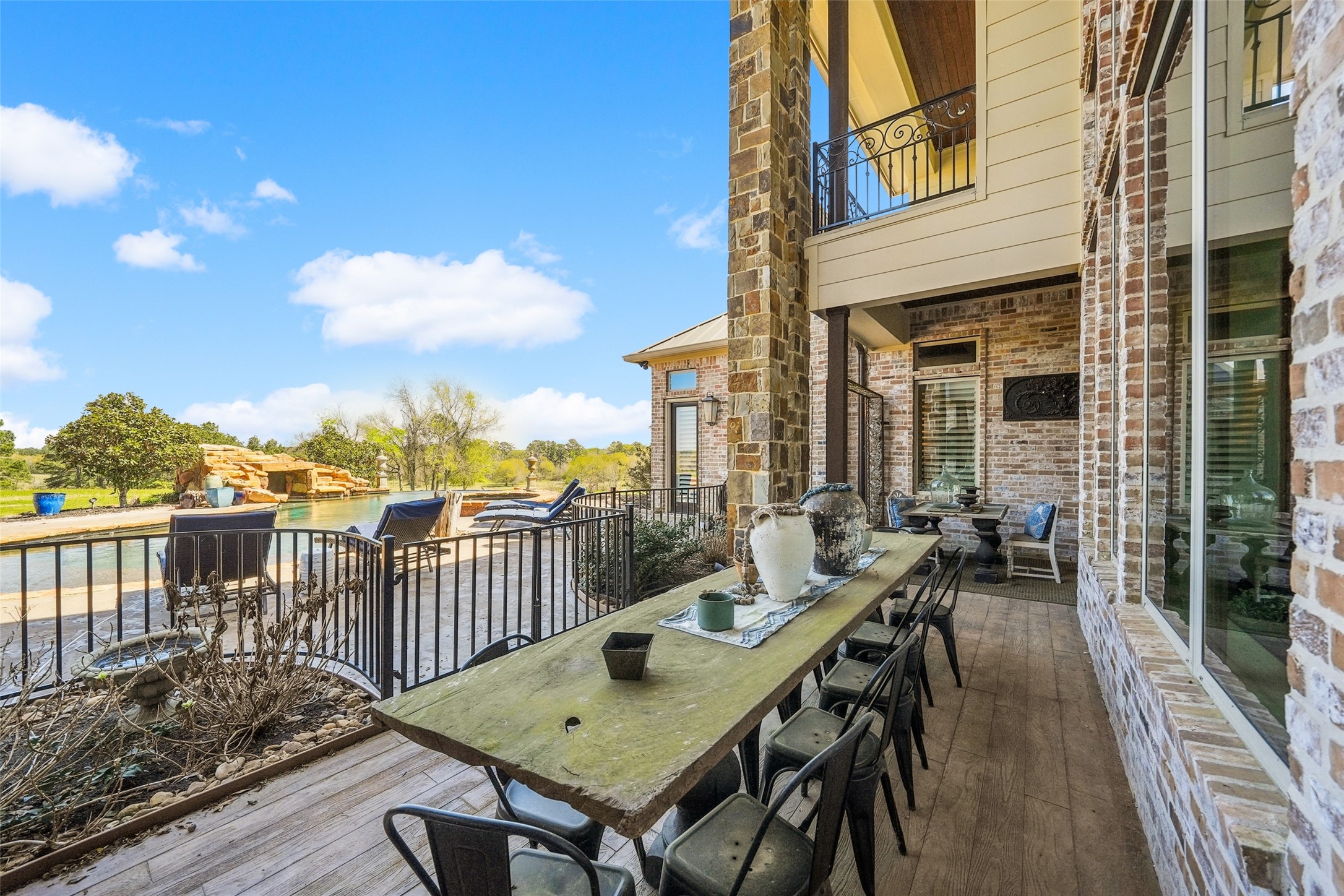 460 Bishop Road Huntsville, TX 77320 - Photo 29 of 50 Large windows and open railings enhance the connection between indoor and outdoor spaces, creating a seamless transition with scenic views.