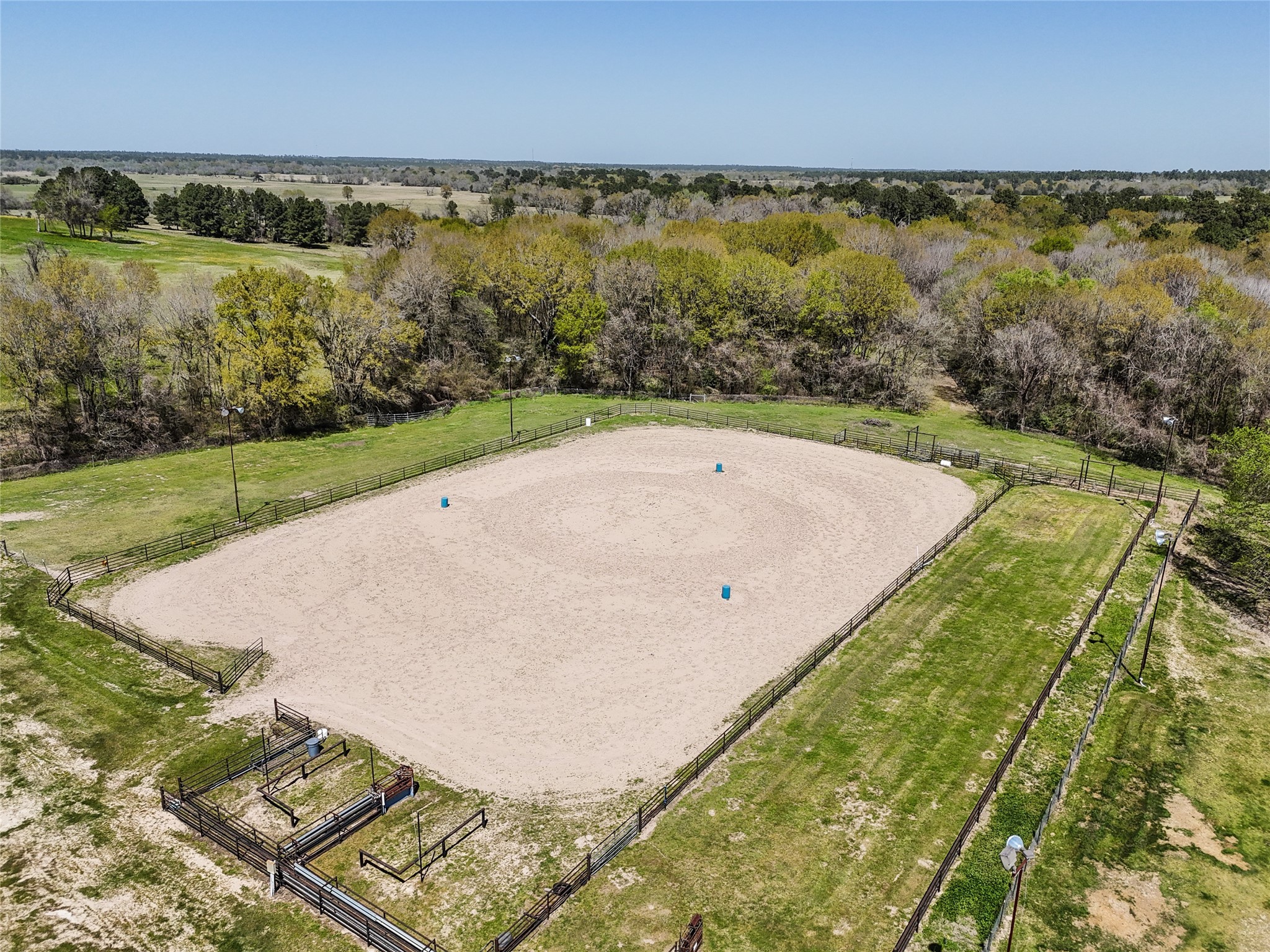 460 Bishop Road Huntsville, TX 77320 - Photo 38 of 50 This 180 ft x 300 ft pipe-fenced arena is equipped with team roping chutes, full perimeter lighting, and well-planned return alleys and pens. It features a separate lane for breakaway roping and pole bending, with excellent footing, good drainage, and automatic waterers for steers.