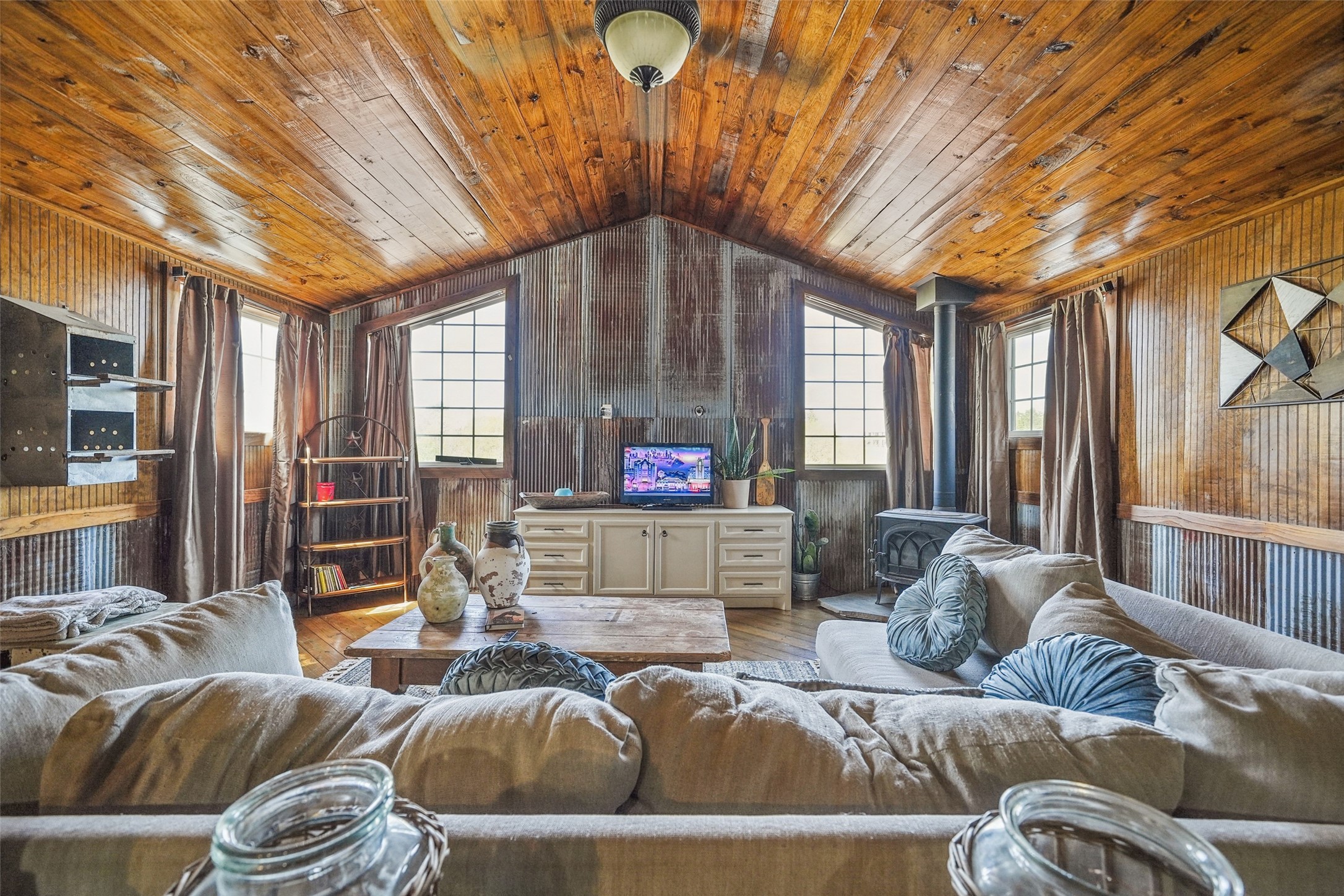 460 Bishop Road Huntsville, TX 77320 - Photo 42 of 50 Rustic yet cozy 1800 sq foot guest house featuring warm wood accents, large windows, and a wood-burning stove. A perfect retreat with charming details and inviting ambiance.
