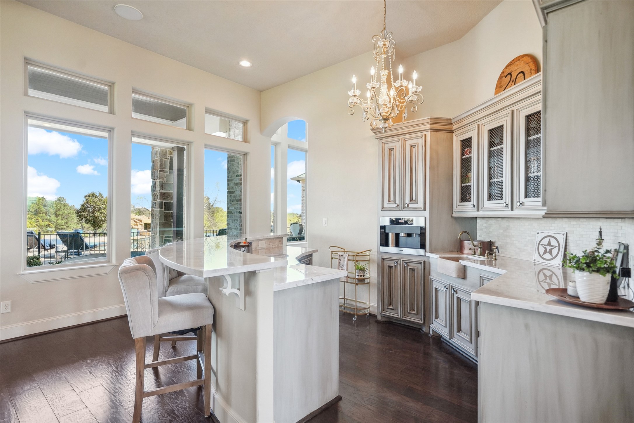 460 Bishop Road Huntsville, TX 77320 - Photo 8 of 50 A dedicated space featuring Carrera marble countertops, a travertine sink, an ice machine, a wine refrigerator, and a built-in plumbed Miele coffee machine.