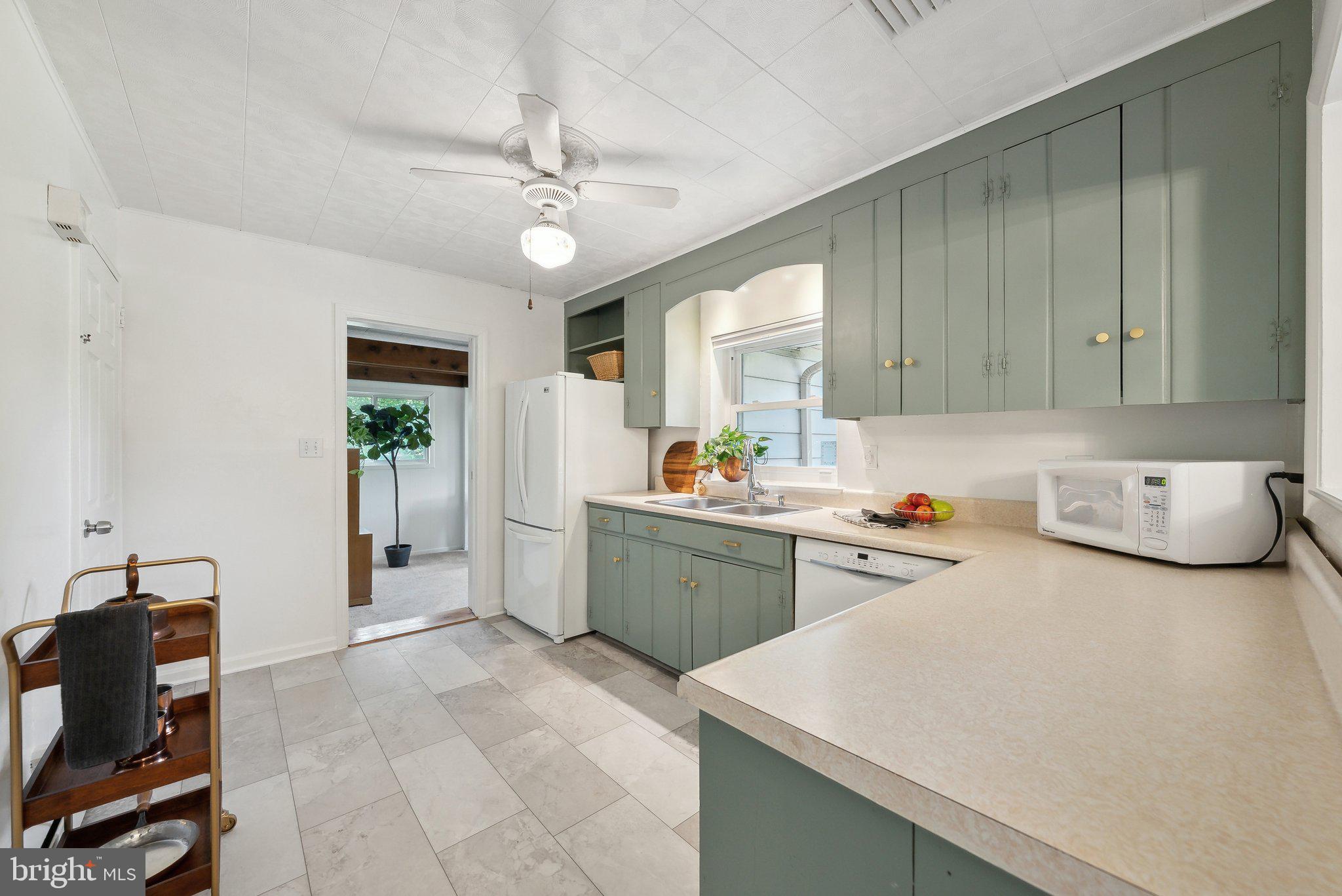 6530 Greenleaf Street Springfield, VA 22150 - Photo 11 of 26 a kitchen with a refrigerator and a sink