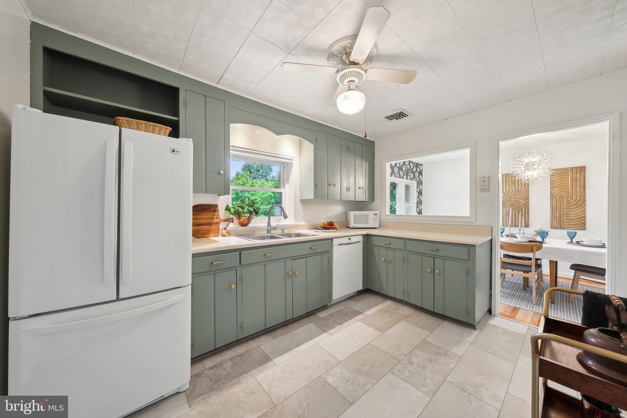 6530 Greenleaf Street Springfield, VA 22150 - Photo 12 of 26 a kitchen with a refrigerator and a sink