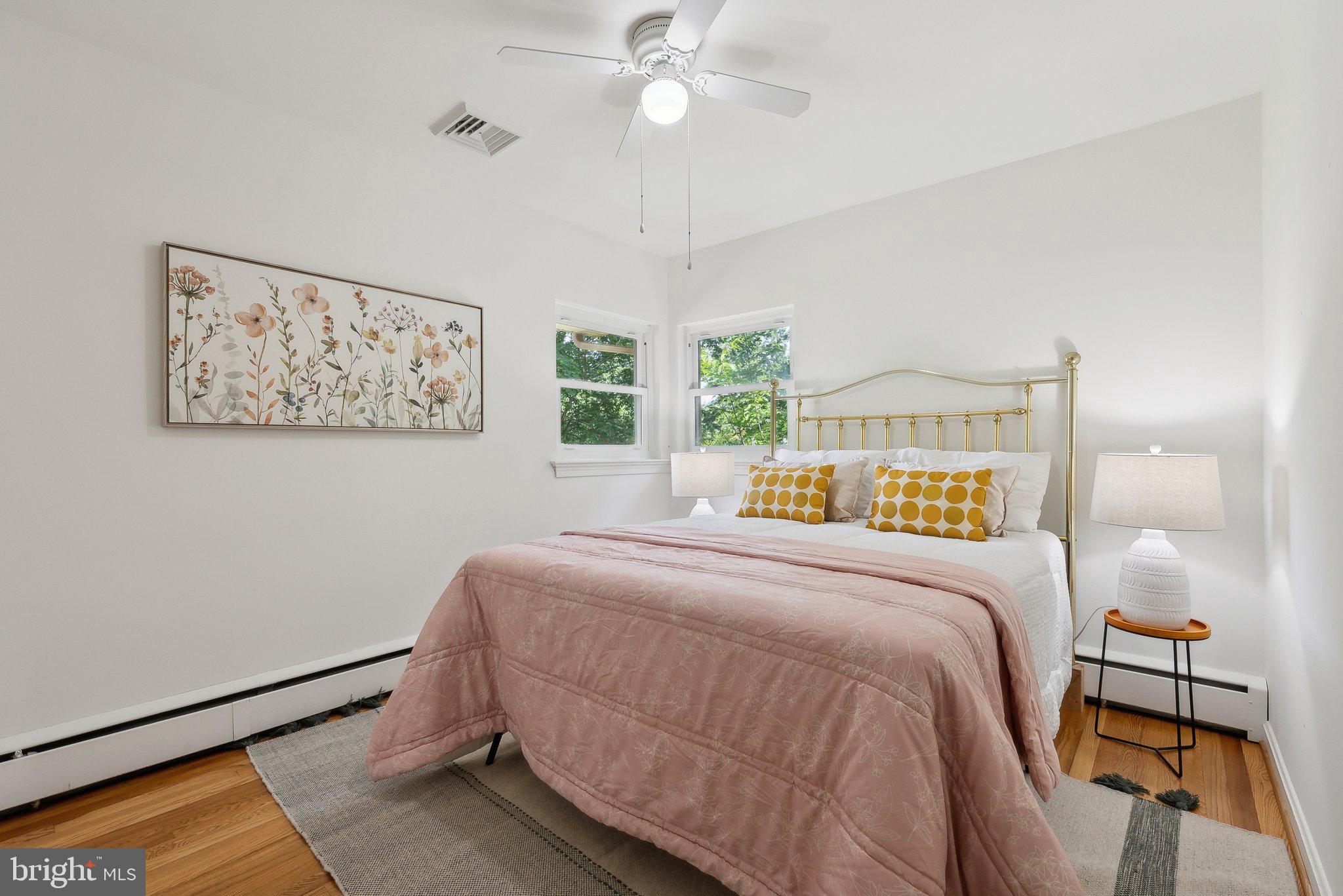 6530 Greenleaf Street Springfield, VA 22150 - Photo 19 of 26 a bedroom with a bed and a chandelier