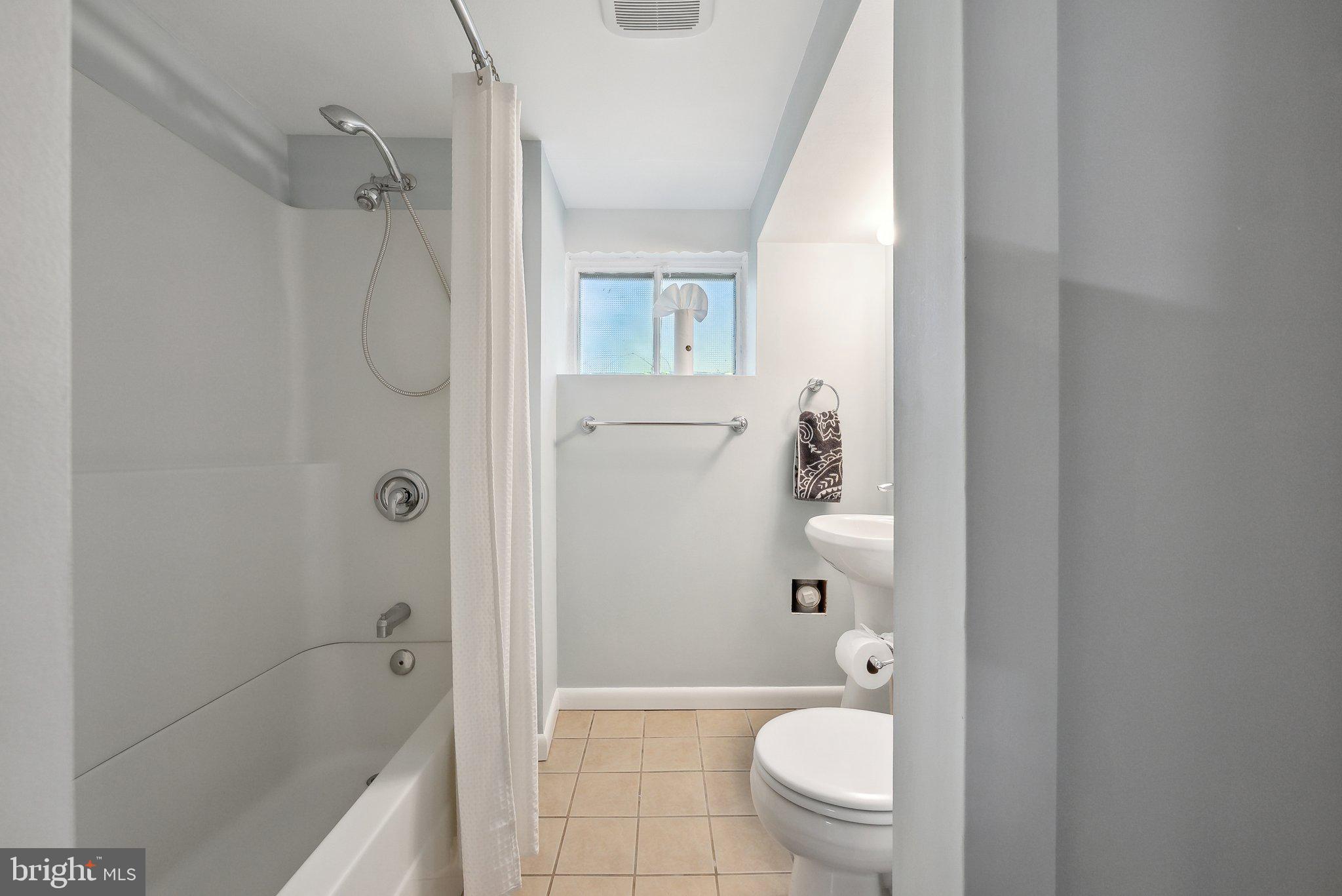 6530 Greenleaf Street Springfield, VA 22150 - Photo 21 of 26 a bathroom with a toilet a sink and shower