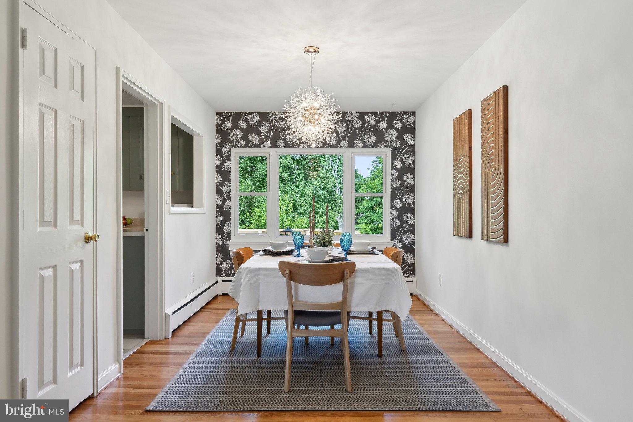 6530 Greenleaf Street Springfield, VA 22150 - Photo 8 of 26 a dining room with furniture a rug and wooden floor