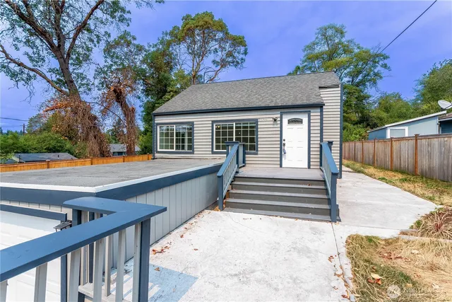 a view of a house with wooden fence
