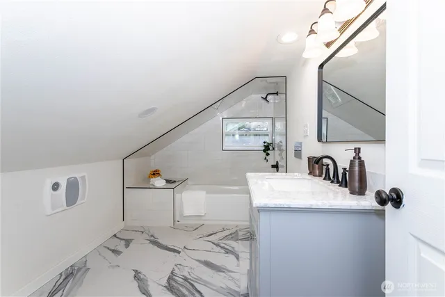 a bathroom with a sink vanity and mirror