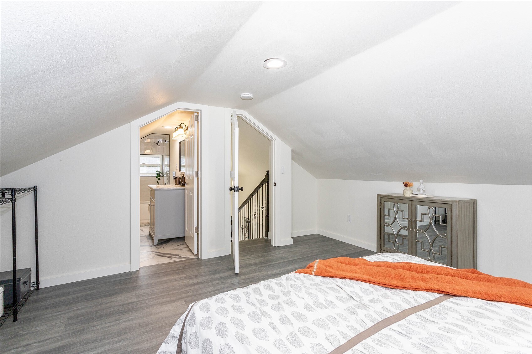 2644 Southwest 112th Street Seattle, WA 98146 - Photo 18 of 33 a bedroom with a large bed and wooden floor
