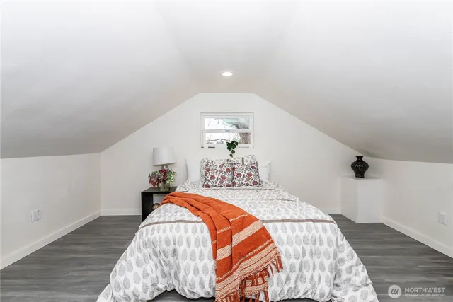 a bed sitting in a bedroom next to a window