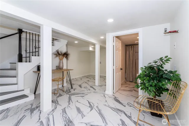 wooden floor with white walls and stairs