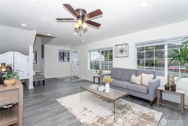 a living room with furniture and view of kitchen