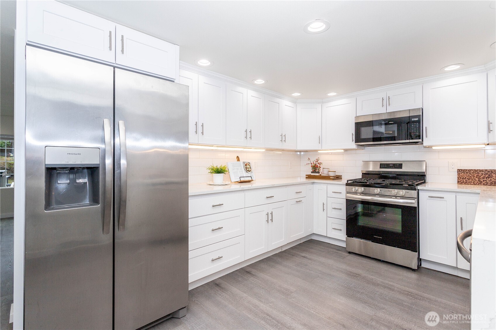 2644 Southwest 112th Street Seattle, WA 98146 - Photo 6 of 33 a kitchen with stainless steel appliances kitchen island granite countertop a refrigerator and a stove top oven
