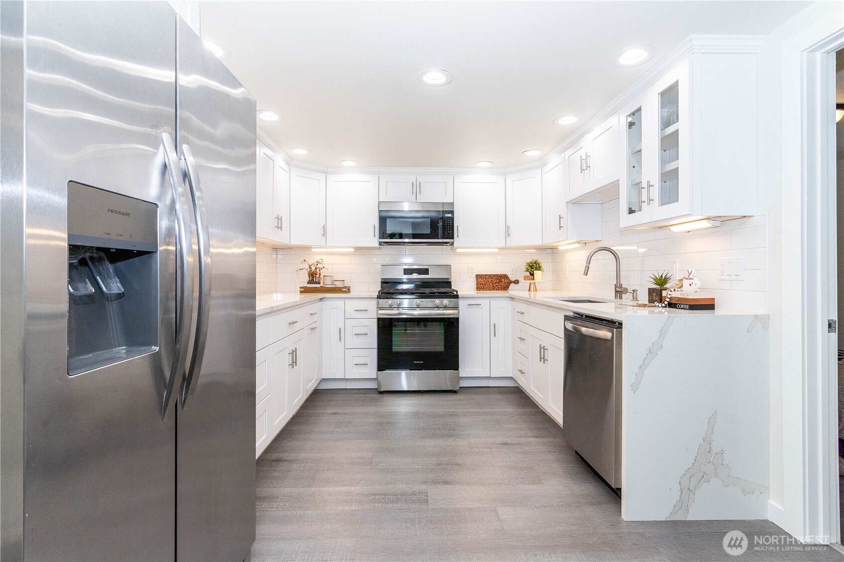 2644 Southwest 112th Street Seattle, WA 98146 - Photo 7 of 33 a kitchen with granite countertop a refrigerator oven a sink and cabinets