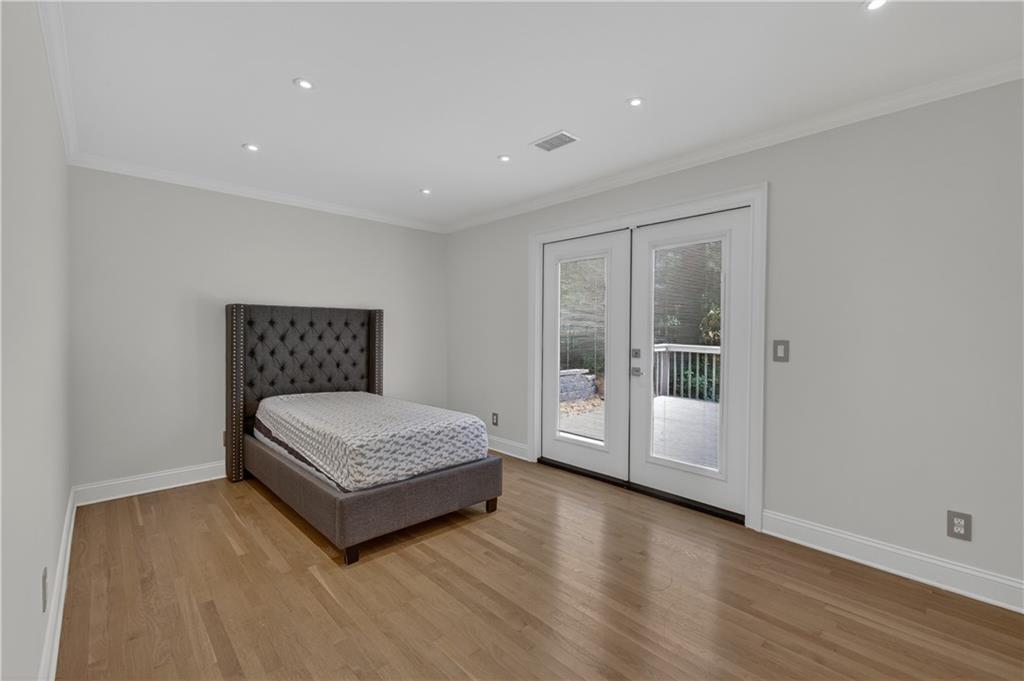 4610 West Morton Road Alpharetta, GA 30022 - Photo 26 of 53 a spacious bedroom with a bed and window