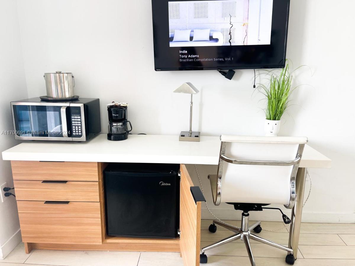 2602 East Hallandale Beach Boulevard, Unit R508 Hallandale Beach, FL 33009 - Photo 18 of 43 a bathroom with a sink and a mirror