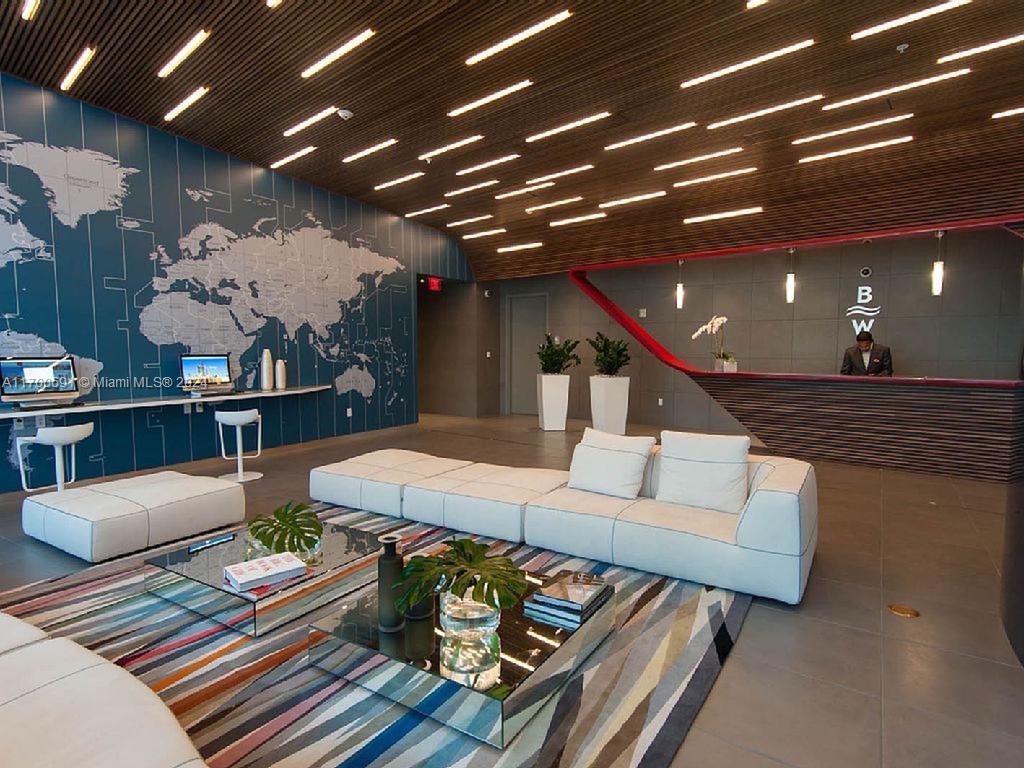 2602 East Hallandale Beach Boulevard, Unit R508 Hallandale Beach, FL 33009 - Photo 8 of 43 a living room with furniture and a chandelier