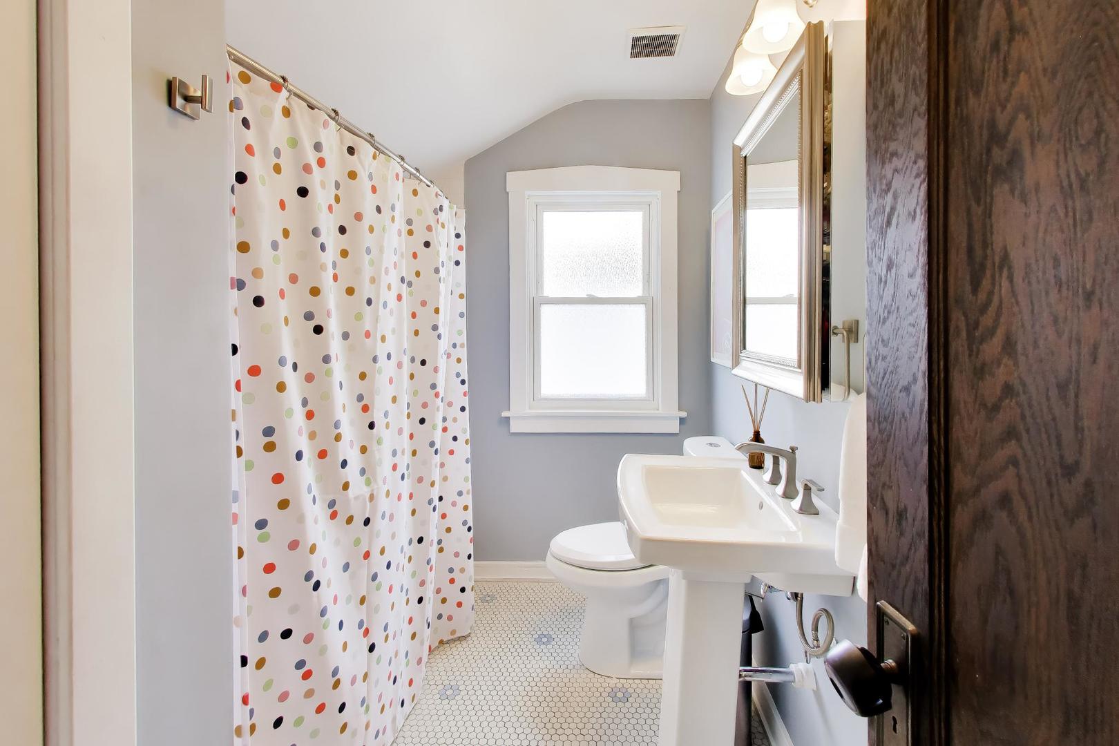 6101 West Patterson Avenue Chicago, IL 60634 - Photo 27 of 40 a bathroom with a sink a toilet a shower curtain and a large mirror