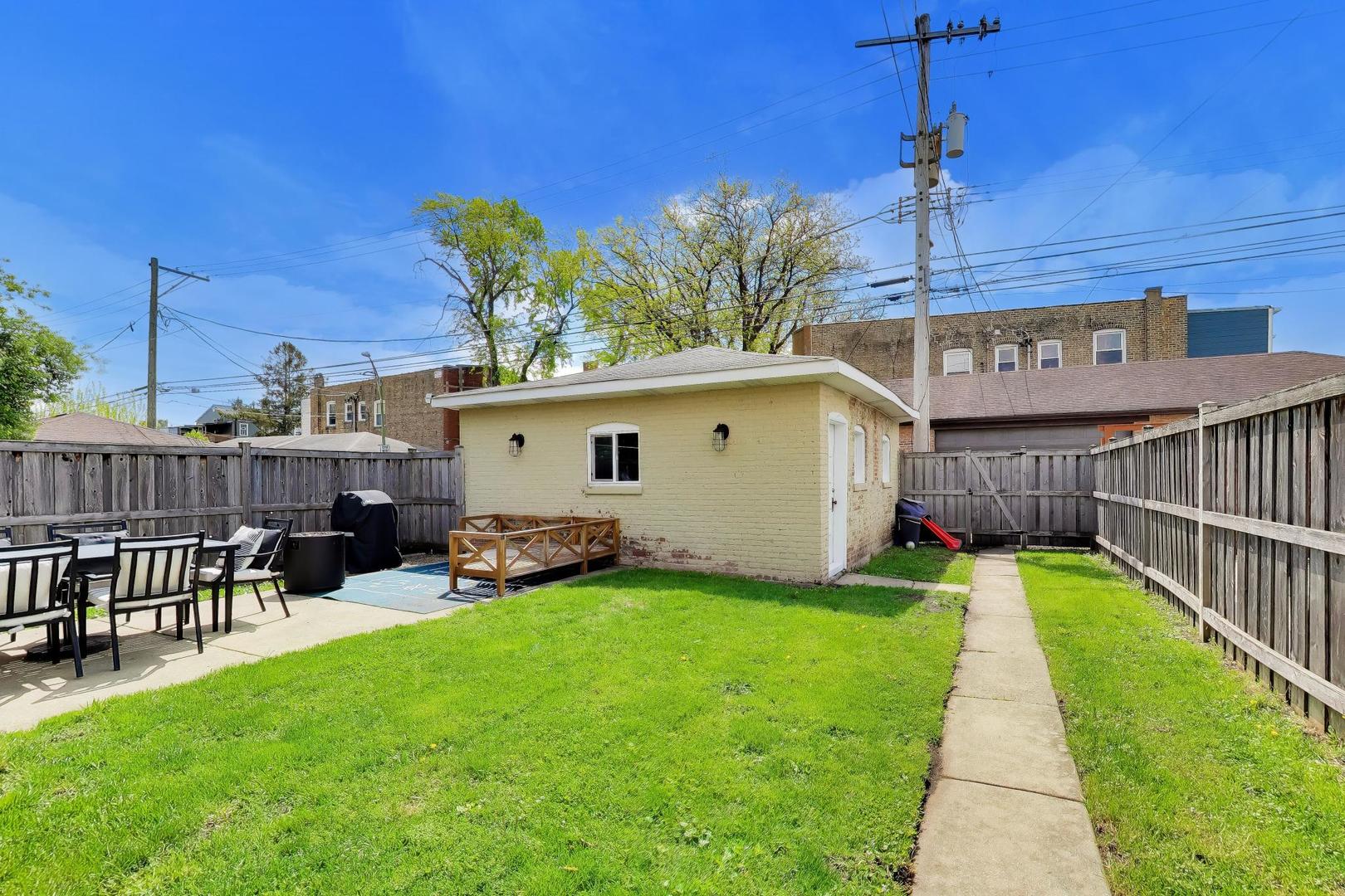 6101 West Patterson Avenue Chicago, IL 60634 - Photo 39 of 40 a view of a house with a yard and sitting area