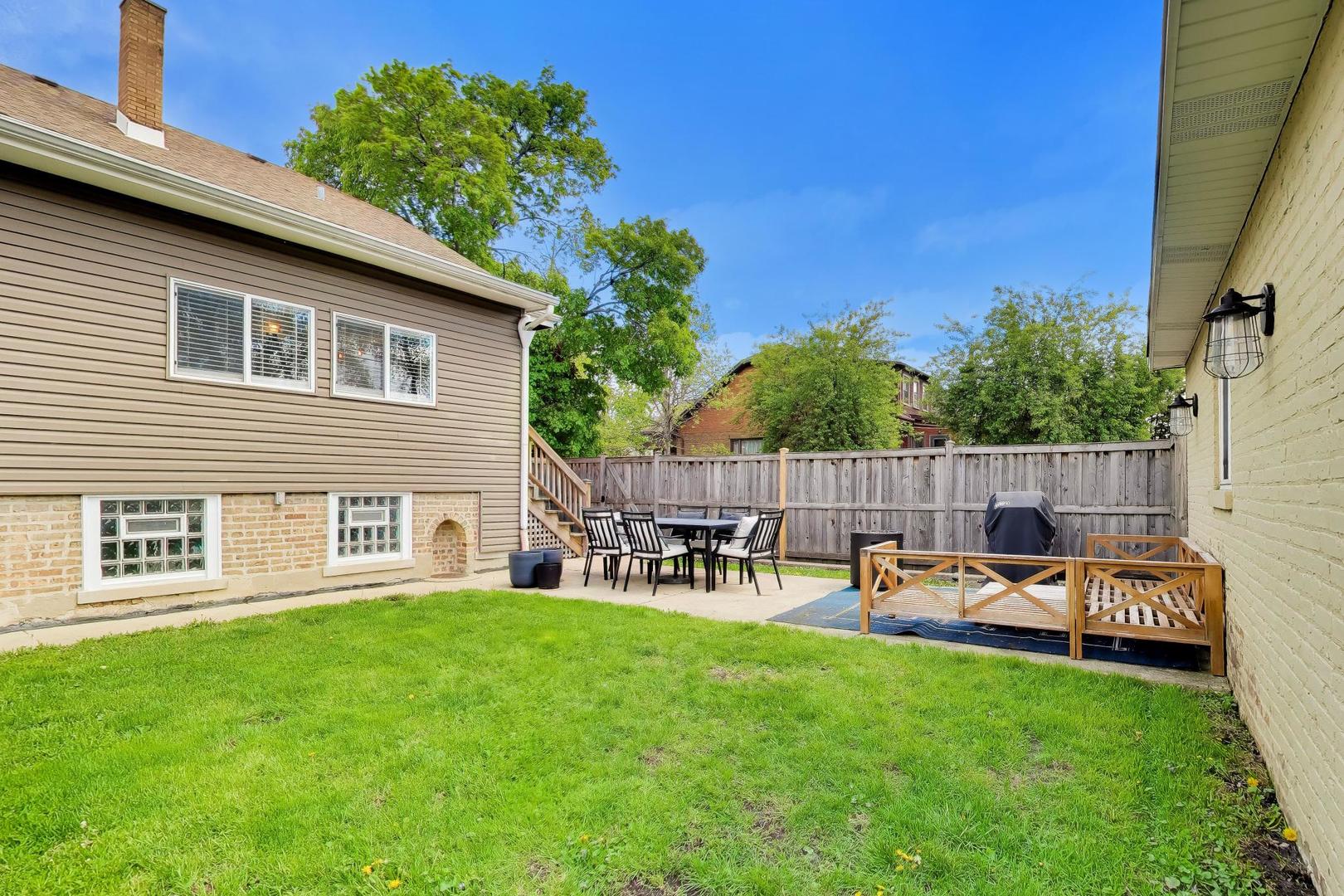 6101 West Patterson Avenue Chicago, IL 60634 - Photo 40 of 40 a backyard of a house with table and chairs