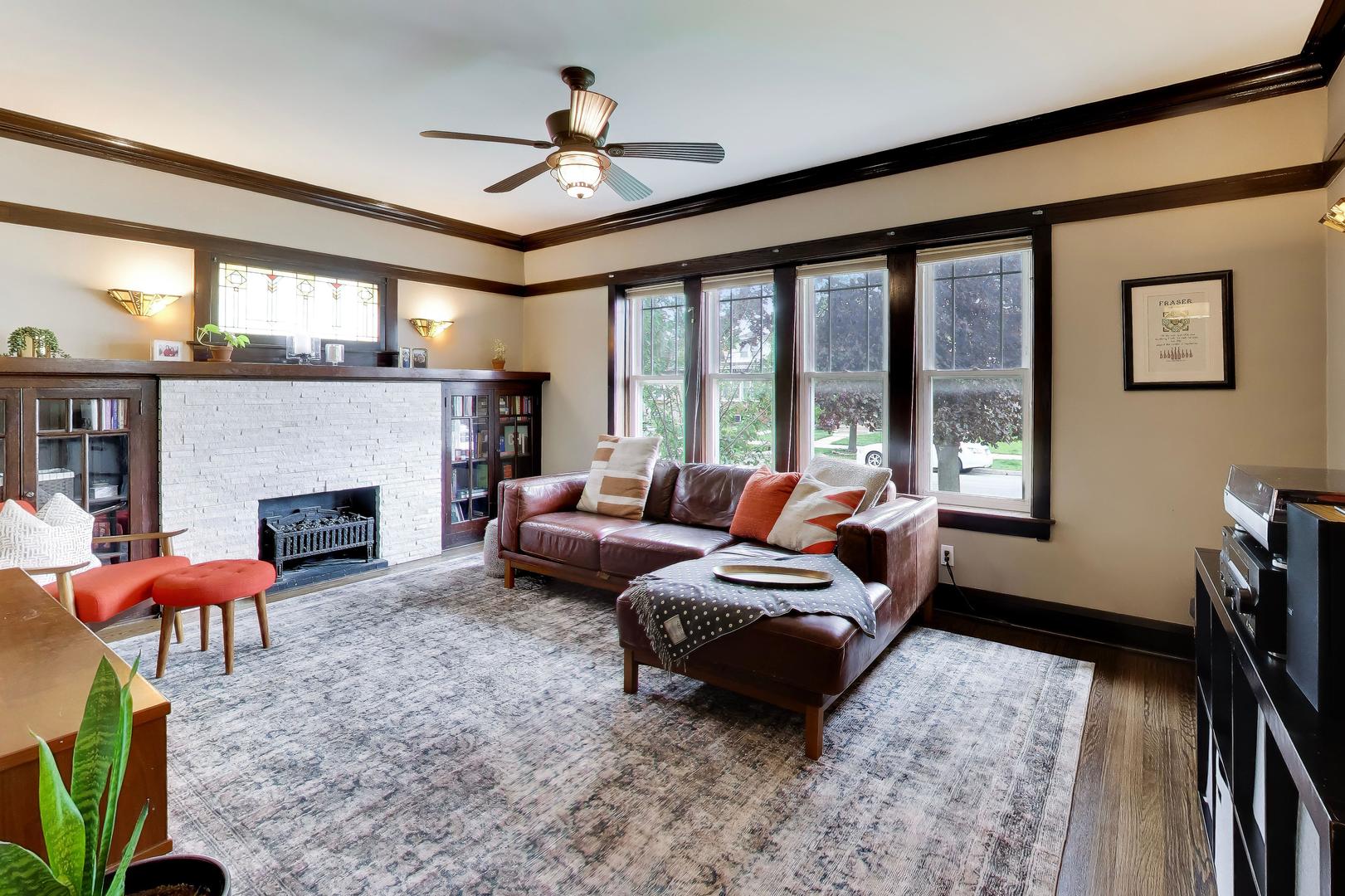 6101 West Patterson Avenue Chicago, IL 60634 - Photo 5 of 40 a living room with furniture a fireplace and a floor to ceiling window