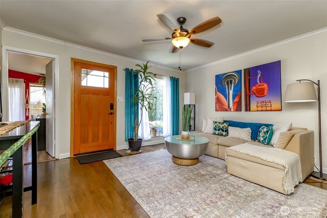 a living room with furniture flowerpot and window