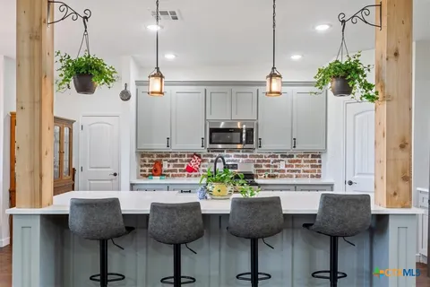 a stove top oven sitting inside of a kitchen