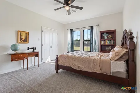 a bedroom with bed and a chandelier