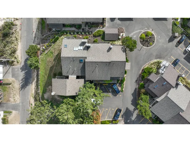 an aerial view of a house with a yard and pool
