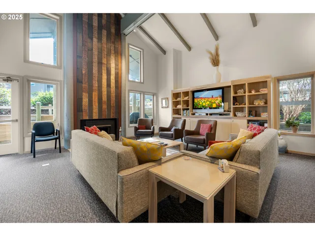 a living room with fireplace furniture and a large window