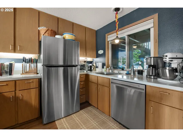 a kitchen with refrigerator a sink and cabinets