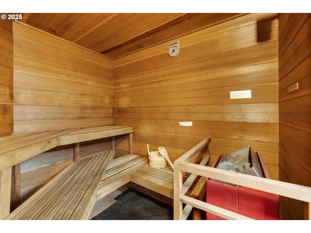 a room with lots of white furniture and gym equipment