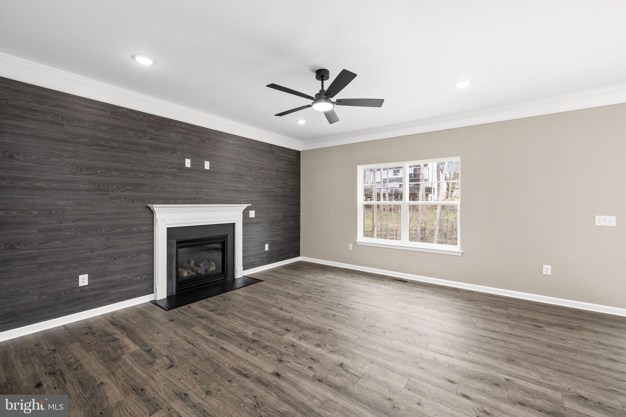 12413 Toll House Road Spotsylvania, VA 22551 - Photo 12 of 68 a view of empty room with wooden floor and fan