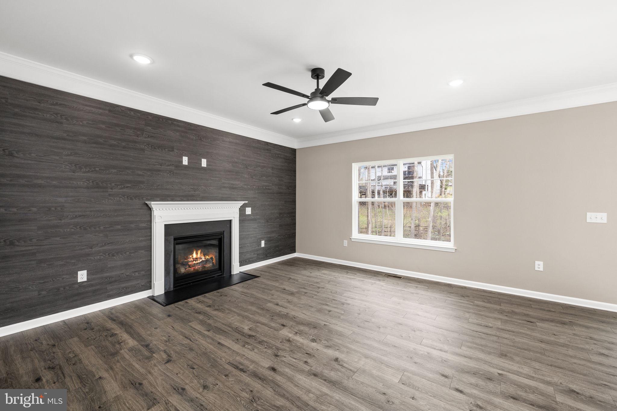 12413 Toll House Road Spotsylvania, VA 22551 - Photo 13 of 68 a view of an empty room with a fireplace and a window
