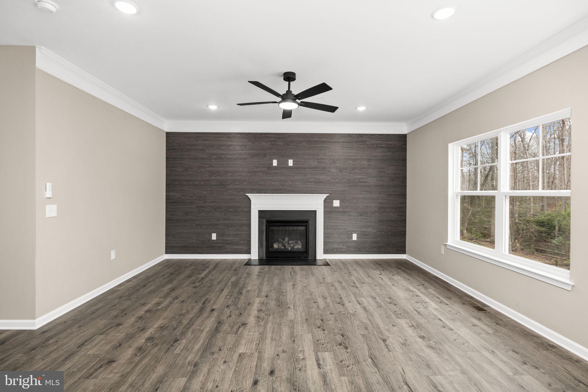 12413 Toll House Road Spotsylvania, VA 22551 - Photo 14 of 68 a view of an empty room with a fireplace and a window