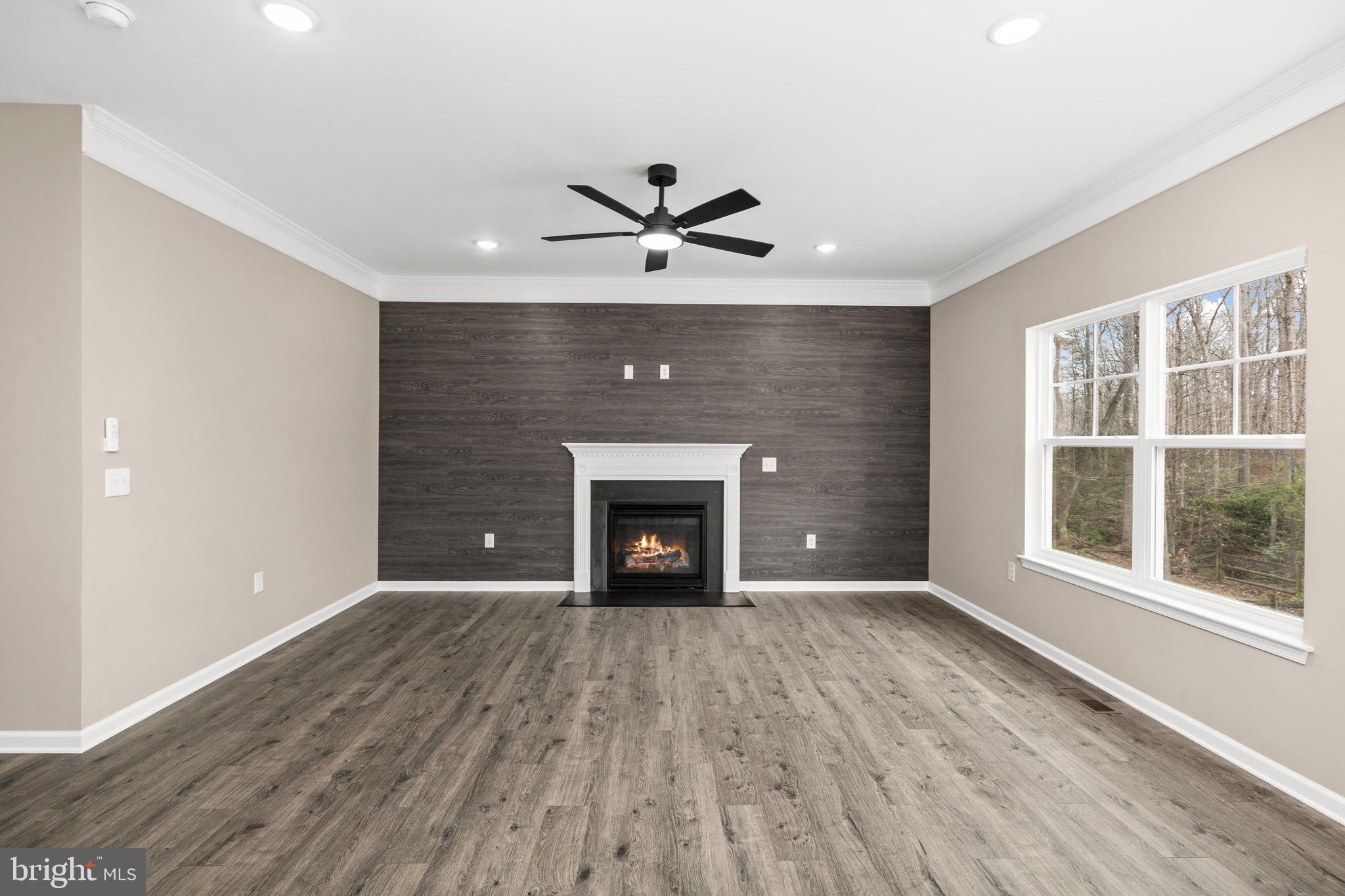 12413 Toll House Road Spotsylvania, VA 22551 - Photo 15 of 68 a view of an empty room with a fireplace and a window