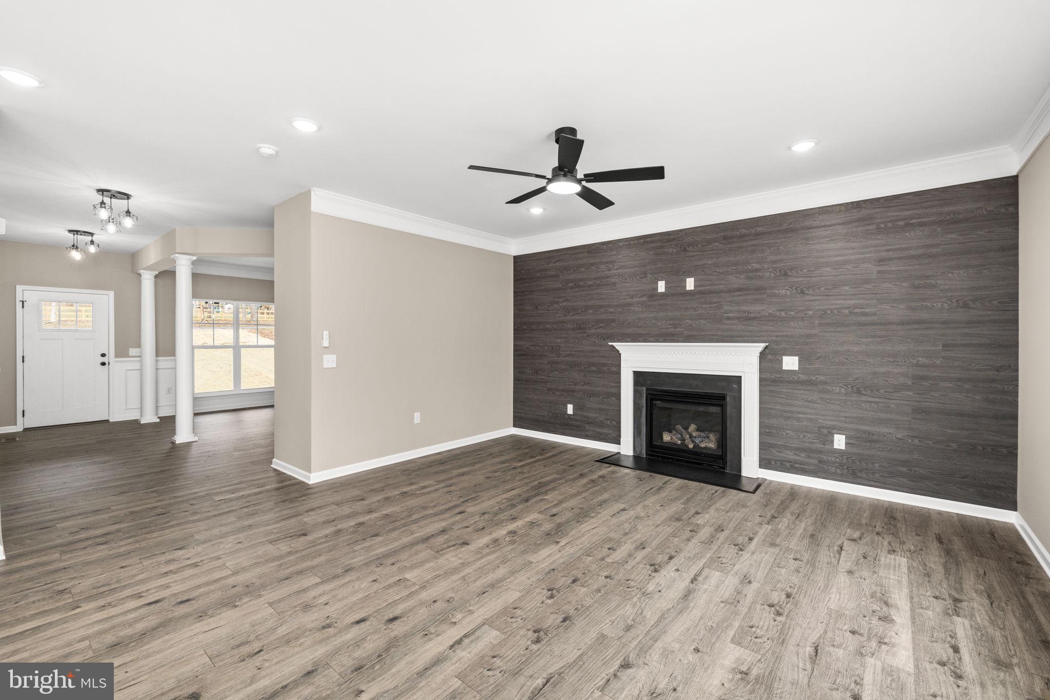 12413 Toll House Road Spotsylvania, VA 22551 - Photo 16 of 68 a view of an empty room with a fireplace and a window