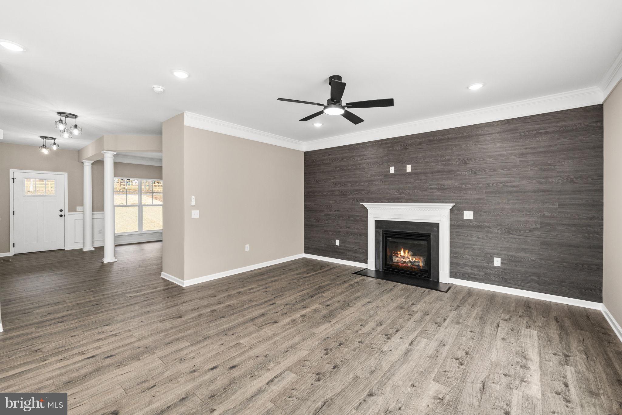 12413 Toll House Road Spotsylvania, VA 22551 - Photo 17 of 68 a view of an empty room with a fireplace and a window