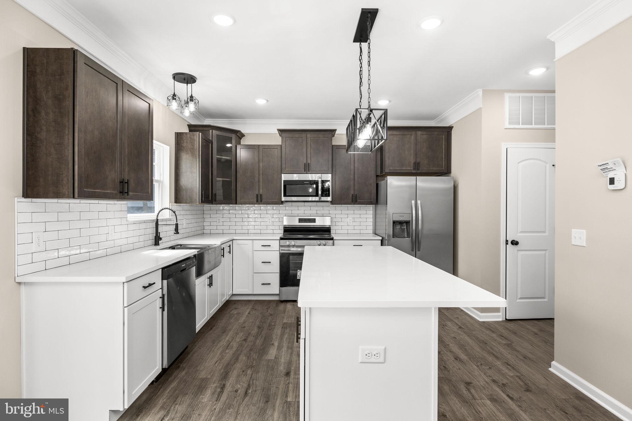 12413 Toll House Road Spotsylvania, VA 22551 - Photo 22 of 68 a kitchen with a sink stainless steel appliances and wooden floor