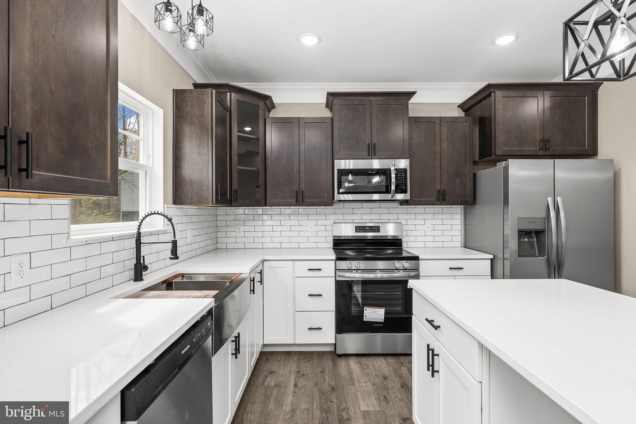 12413 Toll House Road Spotsylvania, VA 22551 - Photo 24 of 68 a kitchen with a sink stainless steel appliances and cabinets