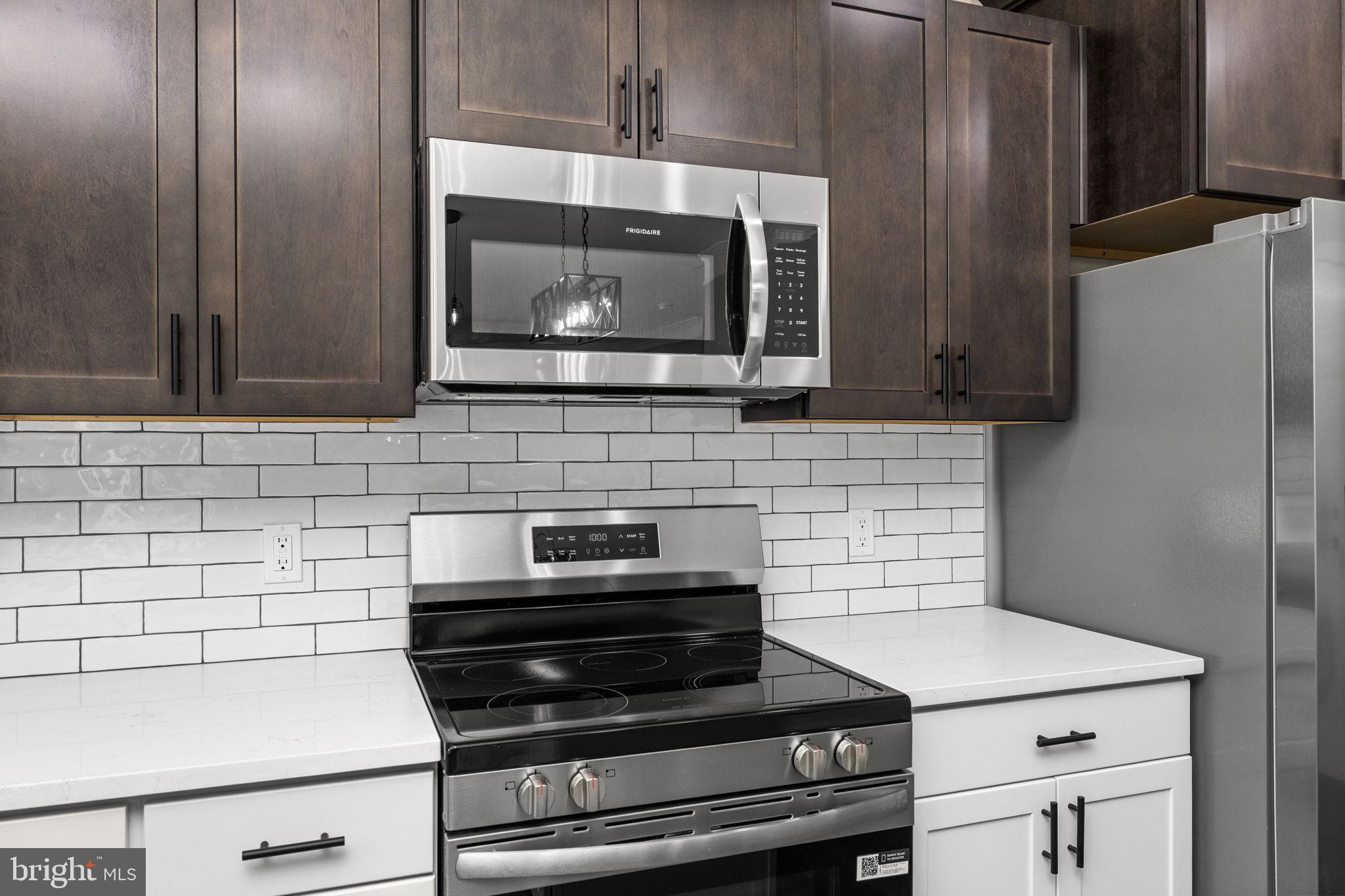 12413 Toll House Road Spotsylvania, VA 22551 - Photo 25 of 68 a kitchen with a stove and a microwave