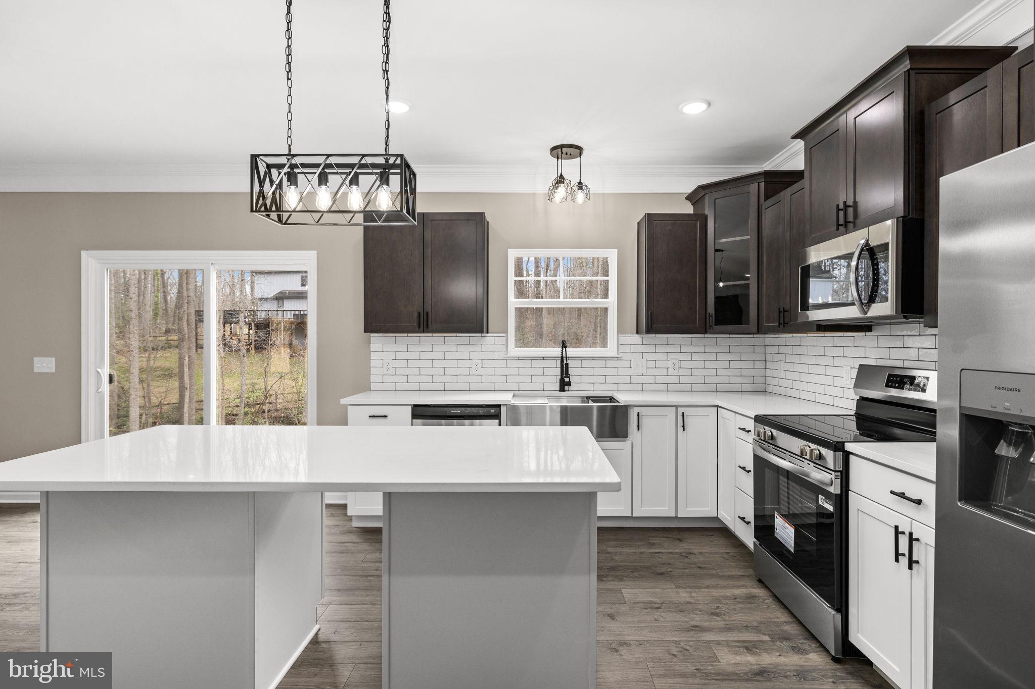 12413 Toll House Road Spotsylvania, VA 22551 - Photo 27 of 68 a kitchen with stainless steel appliances a sink stove and refrigerator