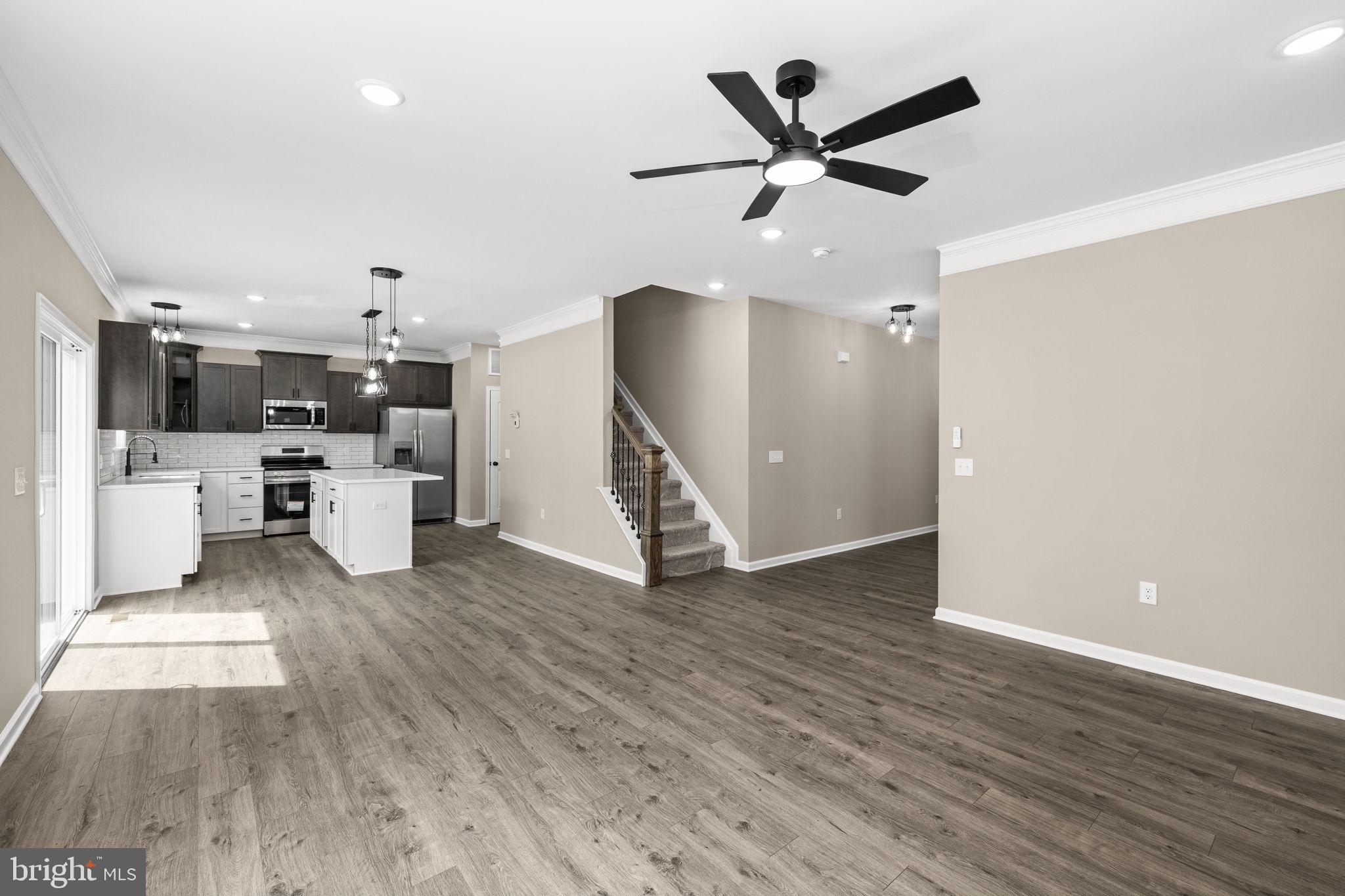 12413 Toll House Road Spotsylvania, VA 22551 - Photo 30 of 68 a living room with wooden floor and a ceiling fan