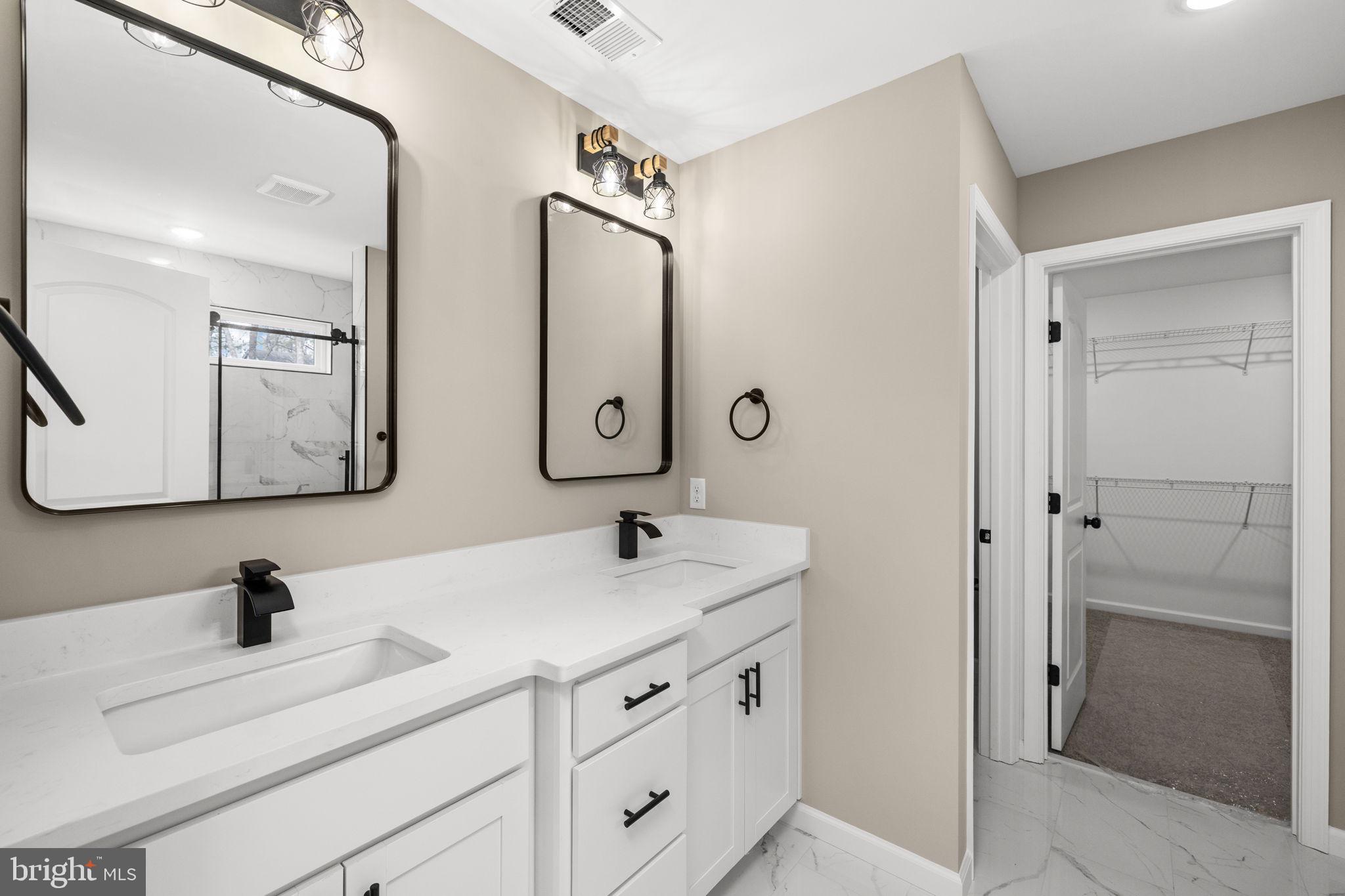 12413 Toll House Road Spotsylvania, VA 22551 - Photo 34 of 68 a bathroom with a double vanity sink mirror and shower