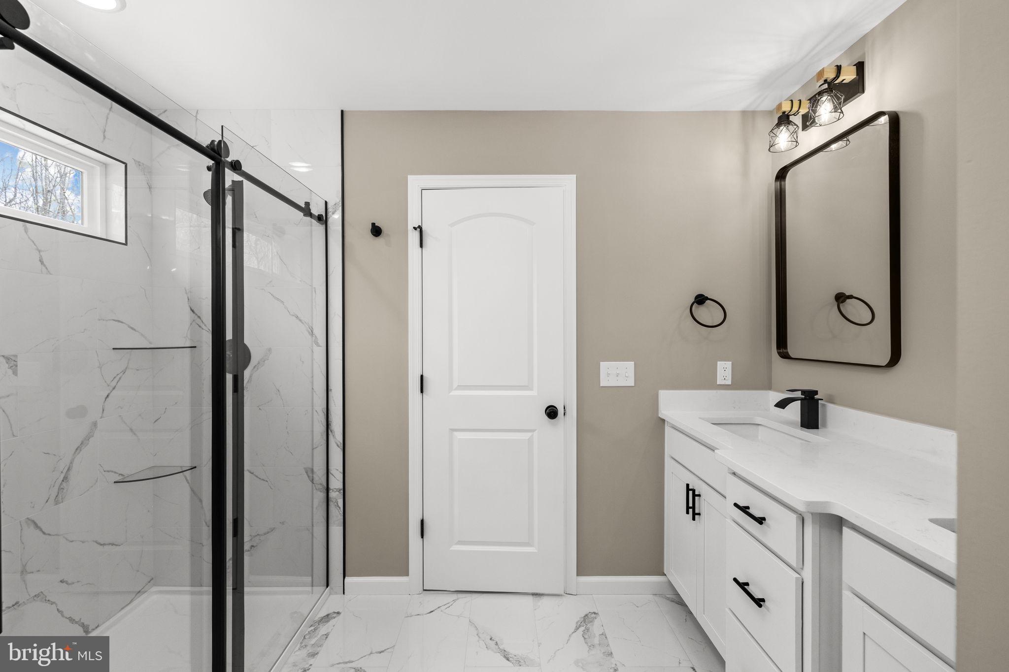 12413 Toll House Road Spotsylvania, VA 22551 - Photo 36 of 68 a bathroom with a double vanity sink mirror and shower